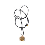 Bondage Pyrite Gold Pendant Necklace by Märta Larsson with raw pyrite crystal wrapped in 14k gold wire. Pyrite pendant necklace on adjustable leather cord — bold, handcrafted, and rebellious.