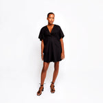 Luxury black short silk kaftan dress by Märta Larsson with elegant drape and empire cut.