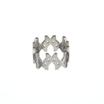 Product image of the MMM Brushed Silver Ring by Märta Larsson, displayed against a white background. The ring features a continuous band of engraved Märta “M” logos forming a bold, crown-like silhouette. Crafted in recycled 925 sterling silver with a brushed finish, the 10 mm wide ring blends graphic edge with everyday elegance.