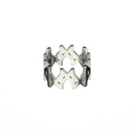 Product image of the MMM Brushed Silver Ring by Märta Larsson, displayed against a white background. The ring features a continuous band of engraved Märta “M” logos forming a bold, crown-like silhouette. Crafted in recycled 925 sterling silver with a brushed finish, the 10 mm wide ring blends graphic edge with everyday elegance.