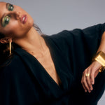 Elegant designer black silk kaftan by Märta Larsson, close-up showing neckline and drape.