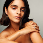 Model wearing The Raw One Shiny Pyrite Earrings by Märta Larsson with sleek bob and minimal makeup. Pyrite drop earrings styled for sharp days and polished nights.