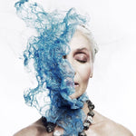 Model wearing Not a Pearl Necklace Calcite Pyrite by Märta Larsson with surreal blue overlay. Raw stone necklace styled for artistic power and expressive fashion.