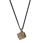Close-up of Bondage Pyrite Silver Pendant Necklace by Märta Larsson with rugged crystal and wire cage. Raw pyrite necklace styled for punk attitude and natural edge.