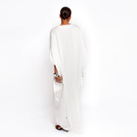 Back view of luxury white silk kaftan dress by Märta Larsson, elegant flowing drape.
