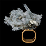 Model wearing Art Ring Special Edition Quartz by Märta Larsson with bold crystal necklace. Clear quartz ring styled for gallery nights and confident fashion.