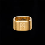 Product image of the Signature Brushed Gold Ring by Märta Larsson, displayed against a black background. The 10 mm wide band in brushed 24 carat gold vermeil stands out with striking contrast, highlighting the ring’s matte texture, minimalist design, and bold presence.