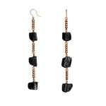 Longing Black Tourmaline Earrings by Märta Larsson with raw black tourmaline stones and gold-plated ear wire. Long crystal drop earrings handcrafted in Stockholm — bold, magnetic, and minimalist.