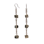 Longing Shiny Pyrite Earrings by Märta Larsson with raw pyrite cubes linked by gold chain. Long crystal drop earrings handcrafted in Stockholm — radiant, geometric, and bold.