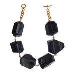 Not A Pearl Necklace XXL Black Tourmaline by Märta Larsson with oversized raw black tourmaline stones linked by 14k rolled gold and 18k gold-plated chain. Statement crystal necklace handcrafted in Stockholm — bold, protective, and unforgettable.