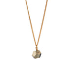 The RawThe Raw One Rough Quartz Necklace by Märta Larsson displayed on white background. Gold vermeil chain with raw quartz pendant — bold contrast and frozen-light glow. One Pyrite Octagon Necklace