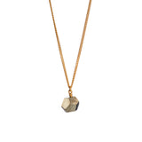 The RawThe Raw One Rough Quartz Necklace by Märta Larsson displayed on white background. Gold vermeil chain with raw quartz pendant — bold contrast and frozen-light glow. One Pyrite Octagon Necklace
