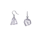 The Raw One Rough Quartz Earrings by Märta Larsson with raw quartz stones and silver hooks. Minimalist crystal earrings — handcrafted and naturally luminous.