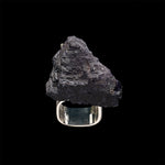Close-up of a hand wearing the Roxx Black Tourmaline Asymmetrical Ring by Märta Larsson. The large raw stone and sculptural gold band make this a standout black tourmaline ring for modern styling.