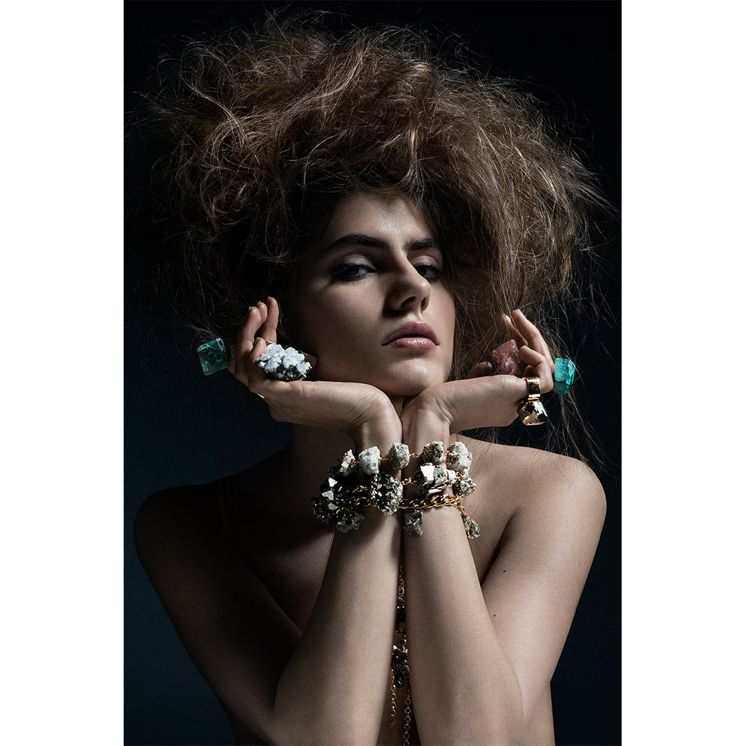Model in dramatic pose wearing the Roxx Chrysocolla Ring by Märta Larsson. Statement ring styled with bold accessories and textured hair — wearable art with mineral elegance.