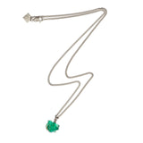 The Raw One Necklace by Märta Larsson featuring a silver chain and raw green fluorite stone, displayed on a white background.