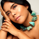 Model wearing Not A Pearl Necklace Chrysocolla by Märta Larsson with gold ring and earring. Raw chrysocolla necklace styled for confident elegance and natural strength.