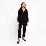 Front view of a model wearing the Bat Wing Silk Top by Märta Larsson, photographed against a white background. The deep V-neck and relaxed fit evoke the effortless elegance of a luxury caftan dress, ideal for styling with statement jewelry or silk kaftan looks.