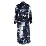 Flat lay of the Glam Rock Silk Satin Shirt Dress by Märta Larsson, displayed against a white background. The clean front design, silk satin texture, and statement silhouette reflect the timeless appeal of fashion-forward shirt dresses for women.