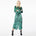 Front view of a model wearing the Glam Rock Silk Satin Shirt Dress by Märta Larsson. This oversized satin shirt dress features a button-through front, crisp collar, and relaxed fit — a bold fashion dress for women perfect for luxury styling and modern rock & roll flair.