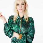 Close-up of the front of the Glam Rock Silk Satin Shirt Dress by Märta Larsson, worn by a model. The silk satin texture and button details highlight the elegance of this designer shirt dress, ideal for fashion-forward women.