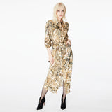 Model wearing the Glam Rock Silk Satin Shirt Dress by Märta Larsson, photographed from the front against a white background. This oversized satin shirt dress features a relaxed fit, button-through front, and crisp collar — a bold fashion dress for women perfect for luxury styling and modern rock & roll flair.