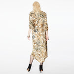 Back view of a model wearing the Glam Rock Silk Satin Shirt Dress by Märta Larsson. The dropped hem and back pleats create a sculptural silhouette, ideal for pairing with fashion accessories or styling as an elegant silk dress.