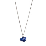 The Raw One Lapis Lazuli Necklace by Märta Larsson in silver with rough blue crystal pendant. Raw lapis lazuli necklace with gold flecks — minimalist and naturally radiant.