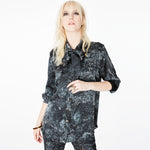 Front view of a model wearing the Boyfriend Silk Satin Shirt by Märta Larsson, photographed against a white background. This relaxed-fit shirt in 100% silk satin features a boyish collar and pocket, offering a laid-back luxury look ideal for pairing with mens fashion jewelry or designer mens jewellery.