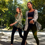 Two models walking outdoors, one wearing the Winona Shirt Dress by Märta Larsson. Captured in motion, the shirt dress flows effortlessly, making it a perfect choice for designer kaftan dresses or luxury caftan looks for women on the go.
