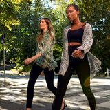 Two models walking outdoors, one wearing the Winona Shirt Dress by Märta Larsson. Captured in motion, the shirt dress flows effortlessly, making it a perfect choice for designer kaftan dresses or luxury caftan looks for women on the go.