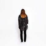 Back view of a model wearing the Winona Shirt Dress by Märta Larsson, set against a white background. The drop hem and flowing silk-cotton fabric create a refined silhouette, ideal for pairing with designer kaftan dresses or styling as a luxury caftan for day-to-night wear.