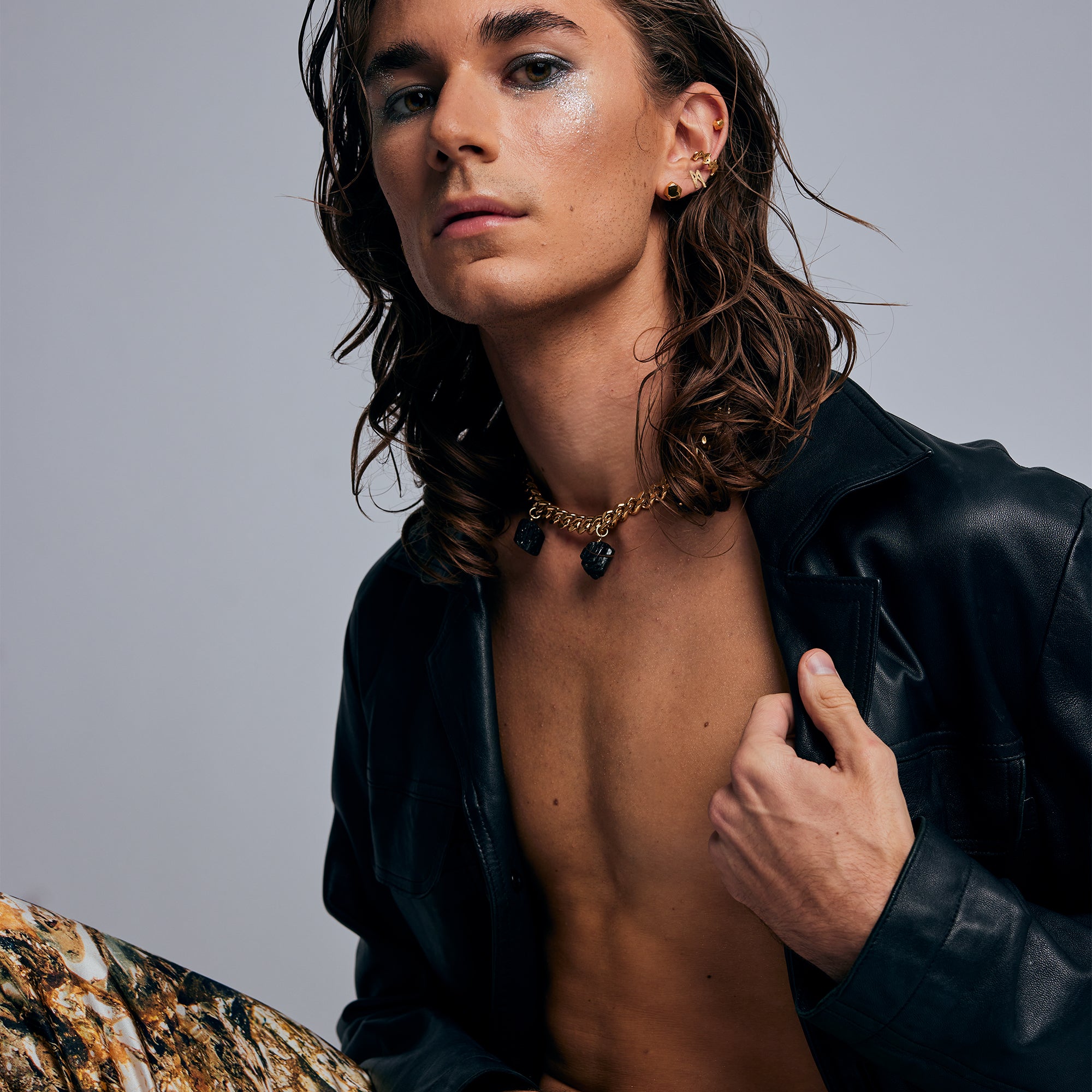 Close-up of Collar Black Tourmaline Necklace by Märta Larsson styled with a leather jacket, a bold raw black crystal piece for an expressive confident look.