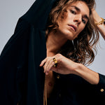 Side view of a male model wearing the Black Tourmaline Ring by Märta Larsson in gold vermeil. The brushed gold finish and geometric stone setting make this a standout tourmaline ring for fashion-forward styling.