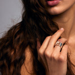 Close-up of hand and lower face wearing the Mondrian Ring Garnet in Limestone by Märta Larsson on the ring finger, a silver statement ring with earthy gemstone.