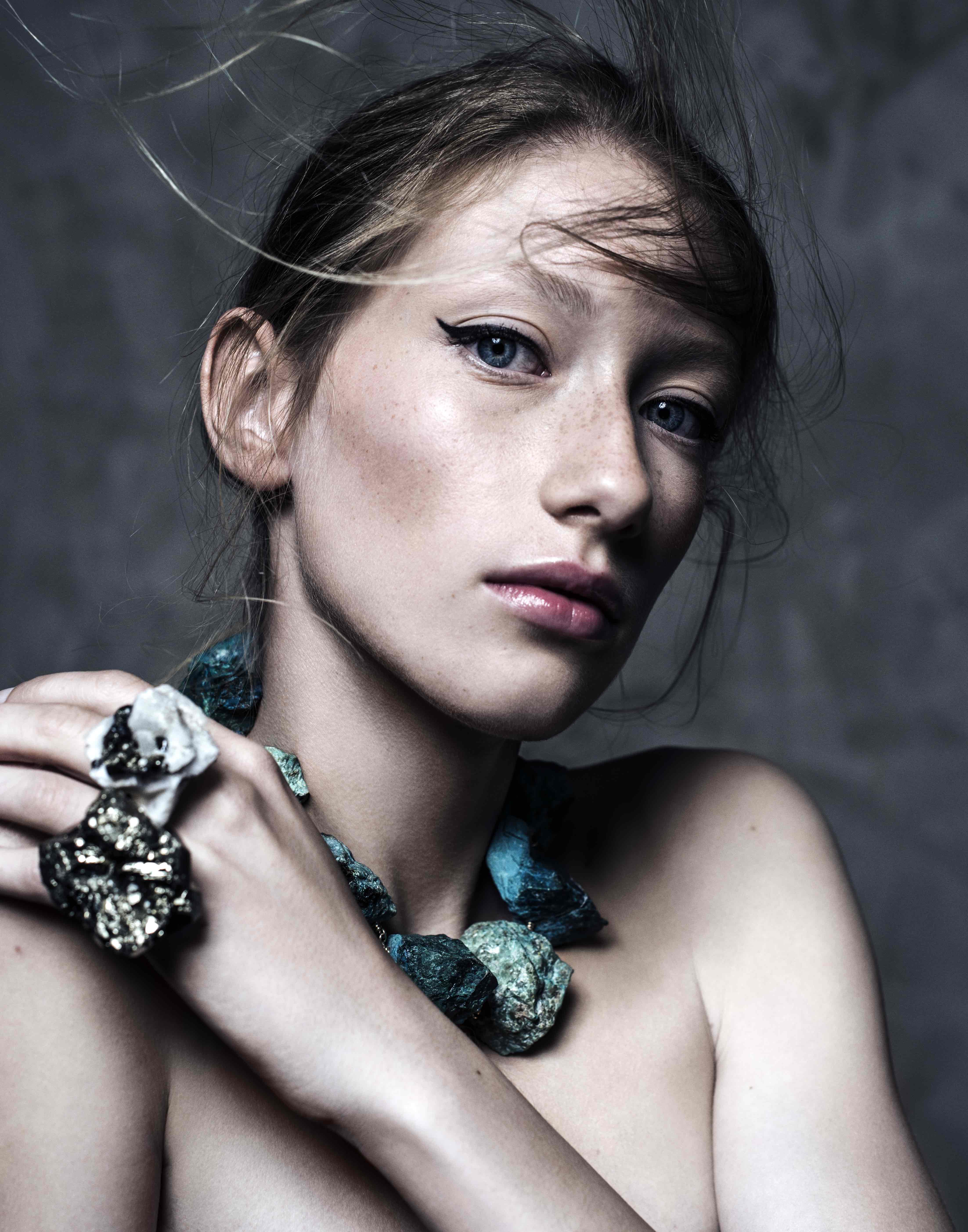 Close-up portrait of model wearing Not A Pearl Necklace Chrysocolla by Märta Larsson, a chunky raw chrysocolla statement piece styled with bold mineral ring.