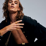 Male model wearing The Power Ring by Märta Larsson in gold vermeil on his pinky finger, featuring a raw crystal and bold wide band with brutalist modern style.