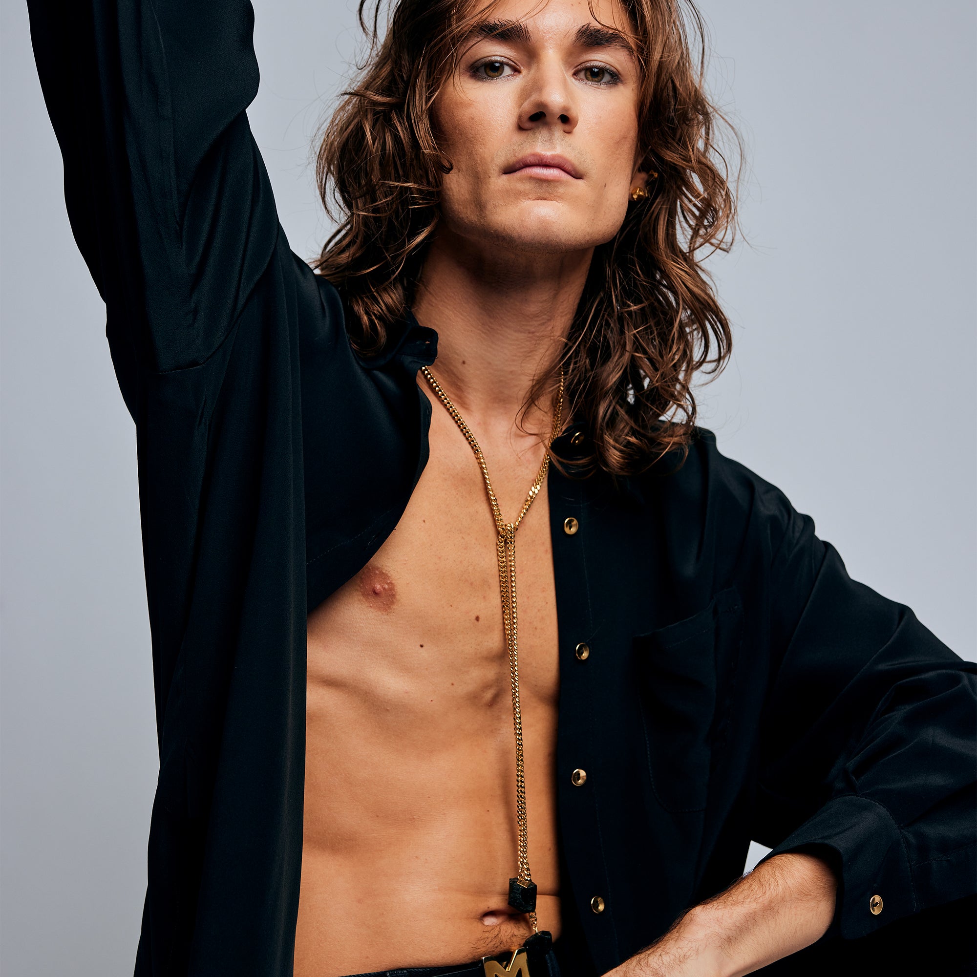 Model in black shirt wearing the Tie Me Up Black Tourmaline Necklace by Märta Larsson, a raw tourmaline lariat styled for modern power dressing.