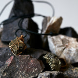 Close-up of pyrite crystal ring by Märta Larsson, highlighting cubic mineral formations and sculptural gold band.