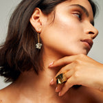 Close-up of a person wearing the Roxx Pyrite Double Cube Ring by Märta Larsson on index finger. Gold vermeil ring with raw pyrite cubes — perfect for brutalist styling and confident fashion.
