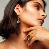 Close-up of a person wearing the Roxx Pyrite Double Cube Ring by Märta Larsson on index finger. Gold vermeil ring with raw pyrite cubes — perfect for brutalist styling and confident fashion.
