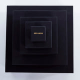 Roxx Pyrite Double Cube Ring by Märta Larsson placed in concentric black boxes with gold branding. Elegant packaging for handcrafted gemstone rings and luxury accessories.