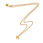 Model wearing the Signature Necklace Brushed Gold Vermeil by Märta Larsson with matching bracelet and earrings, styled for bold everyday elegance.