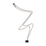 The Raw One Black Tourmaline Necklace by Märta Larsson in silver with a rugged cube-shaped crystal pendant, a sculptural tourmaline piece with protective energy.