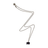 The Raw One Black Tourmaline Necklace by Märta Larsson in silver with a rugged cube-shaped crystal pendant, a sculptural tourmaline piece with protective energy.