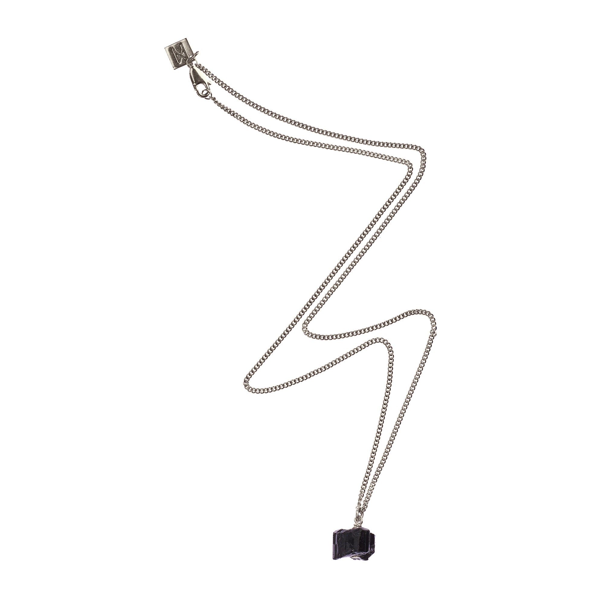 The Raw One Black Tourmaline Necklace by Märta Larsson in silver with a rugged cube-shaped crystal pendant, a sculptural tourmaline piece with protective energy.