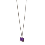 The Raw One Amethyst Necklace by Märta Larsson with raw purple crystal on gold chain, a bold modern amethyst statement piece