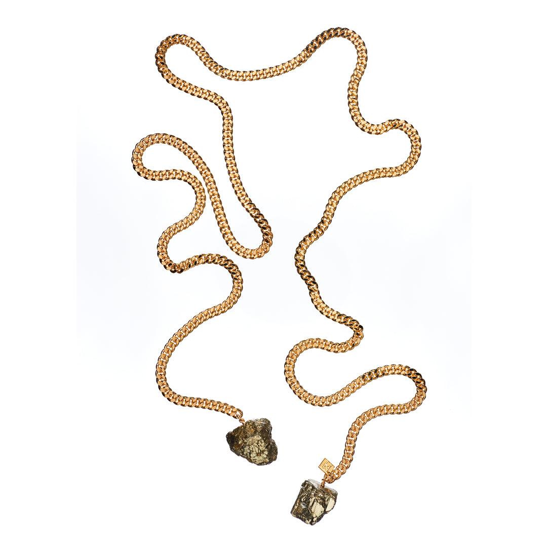Tie Me Up Pyrite Necklace by Märta Larsson with raw pyrite crystal pendants on gold-plated lariat chain. Pyrite necklace handcrafted in Stockholm — bold, metallic, and adjustable.