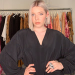 Model in fashion studio wearing Art Ring Special Edition Quartz by Märta Larsson. Statement ring styled with voluminous sleeves and layered earrings — perfect for artistic styling.