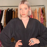 Model in fashion studio wearing Art Ring Special Edition Quartz by Märta Larsson. Statement ring styled with voluminous sleeves and layered earrings — perfect for artistic styling.